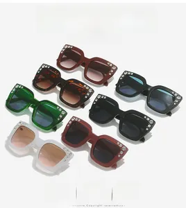 Detailed view of oversized square sunglasses featuring rhinestone-encrusted temples