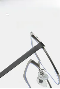 Detailed close-up of flexible metal hinge and adjustable nose pad on optical frame