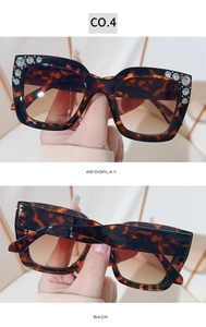 Detail view of square tortoiseshell sunglasses with hand-set rhinestones and brown lenses