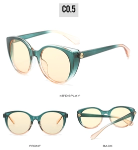Détails de lunettes œil de chat avec monture dégradée vert-orange et verres jaunes
