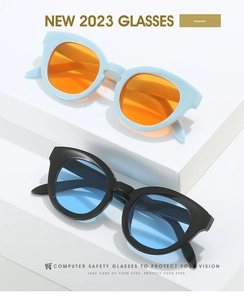 Close-up of stylish oval frame sunglasses with tinted lenses on geometric props