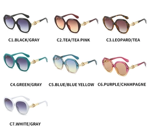 Detail view of seven fashionable oval sunglasses showing colorful frames and golden temples