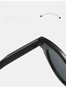 Detailed close-up of the durable reinforced metal hinge on black glossy oval sunglasses