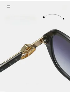 Macro view of durable gold-toned hollow leaf-shaped metal hinges on black sunglasses