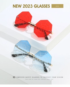Detail of rimless spider web sunglasses in red and blue with gold metal frames