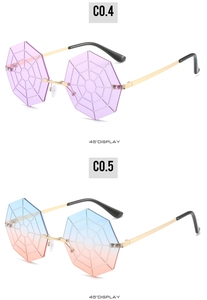 Detail view of octagon rimless sunglasses with spider web patterns in purple and blue-pink