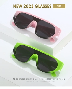 Detail view of oversized flat top sunglasses in gradient pink and green jelly colors