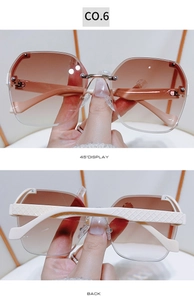Detail view of rimless gradient brown sunglasses with white quilted pattern temples
