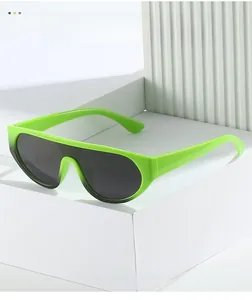 Detail of neon green one-piece wrap sunglasses on a minimalist white display stand