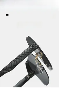 Detail of rimless sunglasses featuring textured black waffle pattern arms and gold metal hinges