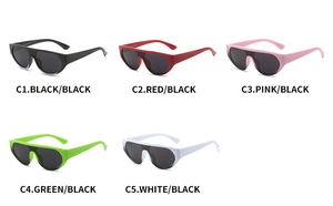 Flat lay of oversized one-piece jelly color sunglasses in black red pink green and white