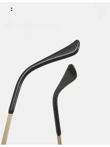 Detail of curved gold metal temples with black tips for spider web rimless sunglasses