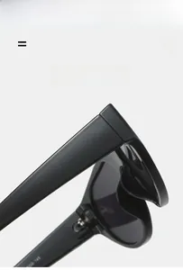 Detail of premium black oversized sunglasses hinge and temple with frame specifications