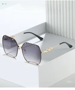 Detail of rimless gradient purple sunglasses with gold chain temples and metal studs