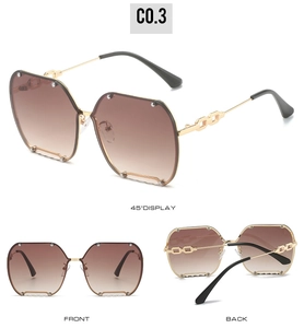 Detail view of rimless octagon sunglasses with chain temples and rivet lens accents
