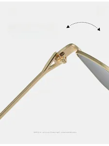 Detailed macro view of the durable gold alloy hinge on oversized square sunglasses