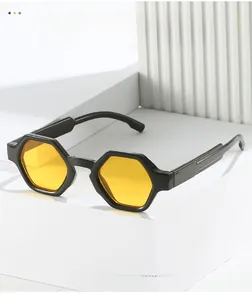 Detailed close-up of hexagonal sunglasses with yellow lenses on white geometric stairs