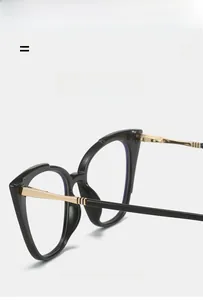 Detail of cat-eye frame with gold metal temples and vertical decorative texture