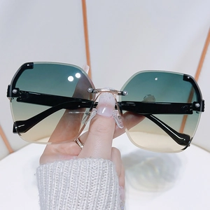 Frameless oversized gradient lens sunglasses with gold metal bridge and black temples