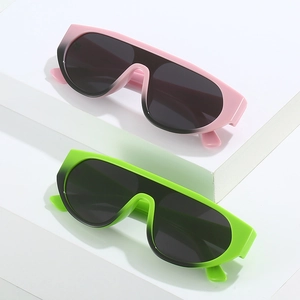 Oversized gradient jelly-colored sunglasses in pink and green on white display stands