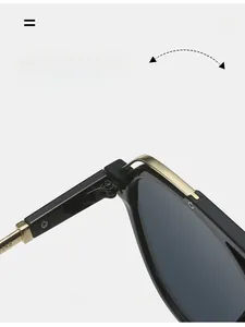 Detail of durable black pilot sunglasses hinge with reinforced golden metal hardware