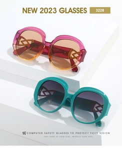 Detail view of oval sunglasses featuring geometric cut-out temples in pastel colors