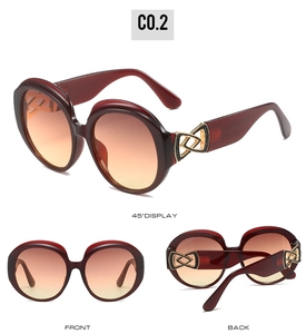 Detail of red wine oval sunglasses with gradient lenses and gold hollow metal temple accents