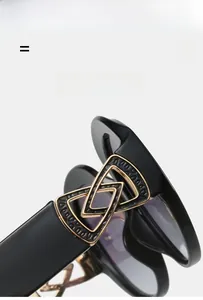 Close-up of lightweight black sunglasses featuring a durable golden elastic hinge