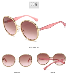 Détails des lunettes de soleil ovales à dégradé rose et monture en métal doré