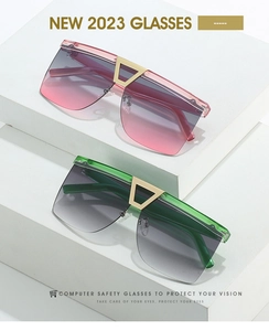 Detail of pink and green gradient oversized sunglasses with geometric gold nose bridge