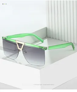 Detail of neon green semi-rimless sunglasses with gold metal triangle accent on the bridge
