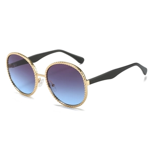 Lunettes de soleil ovales en métal doré à bordure ondulée et verres dégradés bleus