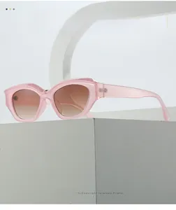 Detail of pink cat-eye sunglasses with gradient lenses on white geometric stands