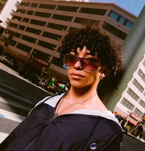 Close-up of retro oversized dark sunglasses with Y2K aesthetic on a fashion model