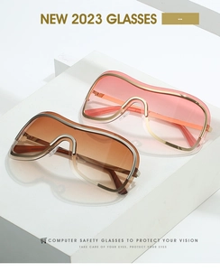 Close-up of stylish Y2K shield sunglasses in tea orange and light pink on white stones