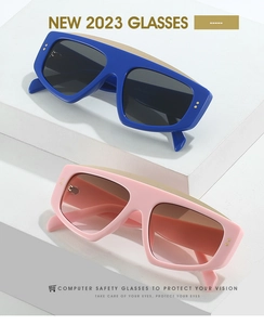 Detail of oversized rectangle sunglasses with thick frames and golden stud accents