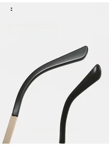 Close-up of black resin temple tips and gold metal frame of Y2K sunglasses