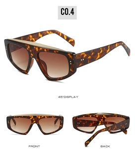 Detailed views of oversized tortoiseshell sunglasses with gold trim and gradient lenses