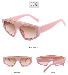 Detailed views of pink oversized sunglasses with gold trim and gradient lenses