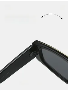 Macro detail of high-quality metal hinge and gold decor on oversized black sunglasses