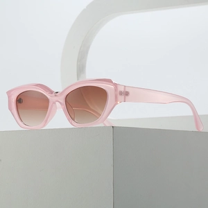 Fashionable pink cat-eye sunglasses with gradient brown lenses on modern display