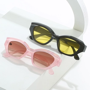 Chic cat eye sunglasses with black frames, yellow lenses and pink gradient eyewear