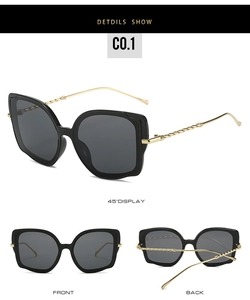 Detailsicht der Cat-Eye-Sonnenbrille mit goldgedrehten Metallbügeln und schwarzem Rahmen