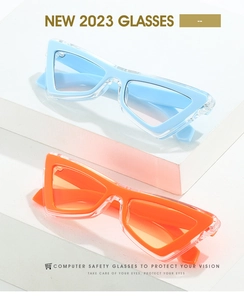 Detail of trendy triangle cat-eye glasses in sky blue and orange colors