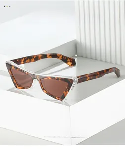 Detail of tortoiseshell triangle cat-eye sunglasses with transparent outer layer texture