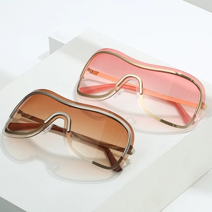 Futuristic oversized one-piece Y2K sunglasses with pink gradient lens and gold frame
