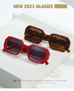 Detail of red and tortoiseshell polygonal frames on white geometric display blocks