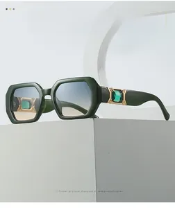 Close-up of polygon sunglasses featuring emerald crystals and gradient lenses