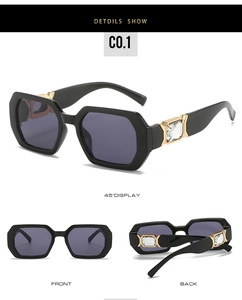 Detail view of black hexagonal sunglasses featuring crystal-studded gold temples