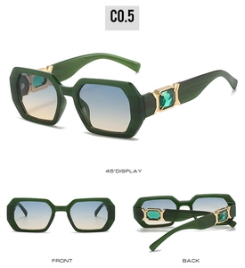 Detail view of green polygon sunglasses with gold metal hinges and emerald crystal accents